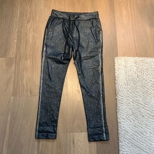 Sparkly and stretchy black pants with little rhinestones on the sides